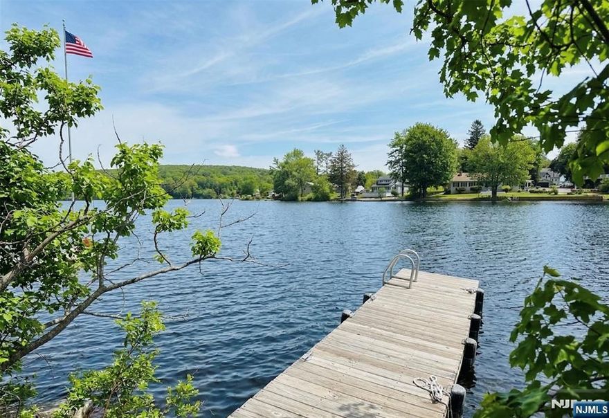 Perched at the high point of Upper Greenwood Lakeâ€™s southern peninsula, this contemporary home is a front-row seat to natureâ€™s best work. If youâ€™ve been chasing a lifestyle that feels like a permanent vacation without the hefty tax bill, you just found the "Golden Ticket" of lakefront living. Airy, modern and sun-drenched, this 3-bedroom, 2-bath open concept has been thoughtfully designed. The kitchen has freshly painted cabinetry, sleek stainless appliances, and a dedicated pantry. The living area, anchored by an inviting wood-burning stove, spills into dining and family spaces where floor-to-ceiling glass acts as a live canvas for the panoramic water views. A bedroom with dual closets, and full bath can also be found on the main floor. The entire upper level feels like a sanctuary, with a primary suite that has a walk-in closet and a spa-inspired en-suite bath. The second bedroom, office nook, and convenient laundry room complete the second floor. With a new roof, vinyl siding, and detached two-car garage, and plenty of room for guests, the only thing on your "to-do" list is relaxing. Enjoy year-round serenity, & explore the potential to dock on the lake with an optional association membership. The private UGL community offers exclusive amenities: a members-only beach & clubhouse, motor boating, kayaking, fishing, jet skiing, & year-round activities. All just one hour from NYC & close to dining, shopping, ski resorts & golf courses.