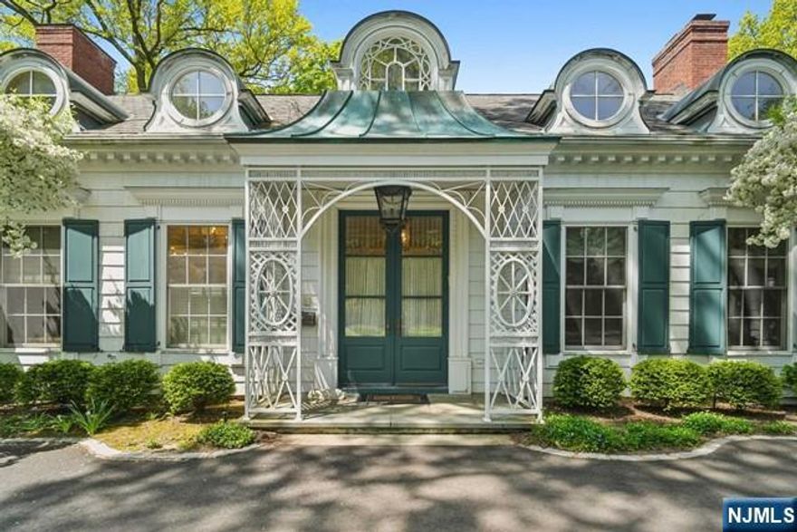 This magnificent French Country home is in the prime East Hill area of Englewood. The welcoming 2 story entry foyer leads to the elegant LR & DR featuring wood floors, high ceilings, a fireplace, & hand-painted mural walls. The custom Clive Christian kitchen w/ intricate woodwork & moldings, Viking & Subzero appliances, 2 dishwashers & a gracious dining area opens to a spacious fam rm. The main floor Primary bedroom suite includes a large spa bathroom, 3 tremendous walk-in closets, a sitting room/library & an office looking out onto the lush backyard. The 2nd level has 3 large bedrooms, 1 w/ ensuite bath, & 1 add'l bath. In the finished basement, you will find a full Kitchen, tons of storage, laundry rm, & a large playrm. This beautiful home sits atop over 1 acre of rolling lawns which include a Gunite heated swimming pool, & a gracious outdoor entertainment area. Conveniently located 5 minutes to GWB, schools, & Downtown Englewood shopping. Very close to all houses of worship.