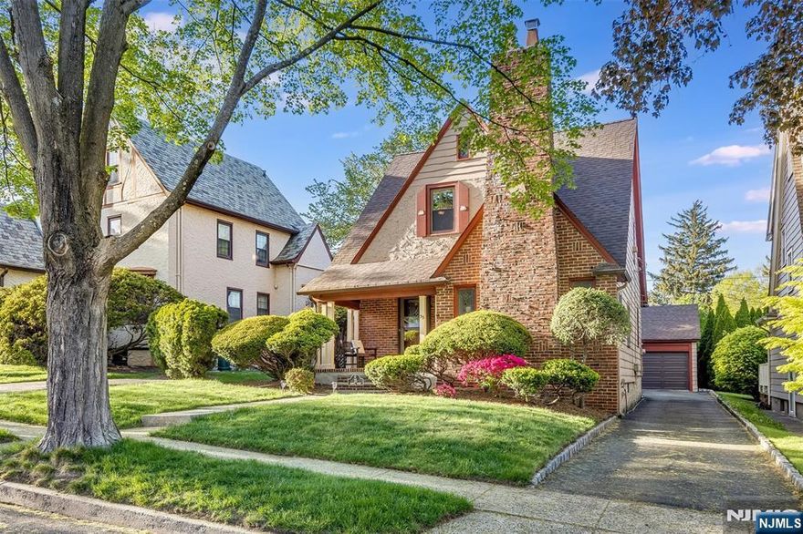 The vintage charm is undeniable in this storybook Tudor on a desirable North End Glen Ridge street. The brick and stucco exterior is ascetically pleasing as well as structurally solid. The covered slate porch is perfect for relaxing and welcoming you home. Inside the spacious foyer leads to formal dining room and the sunken living room with vaulted ceilings. A fireplace and original built-ins complete the magazine worthy living room. The kitchen has an irreplaceable stove along with modern cabinets, countertops and appliances. Plenty of space in the eating nook as well. Take the party outside with access to the wood deck and backyard. Lush landscaping allows for private enjoyment of the outdoor space. A powder room completes the main level. Upstairs you'll find three spacious and light-filled bedrooms and the main bathroom. Semi-finished basement with rec room, additional storage room and utility room. Fresh and neutral paint colors throughout. Ideal location near top-ranked Forest Avenue School. From the front step you can be in Montclair OR Bloomfield in minutes. Imagine all of the shopping, dining and NYC transportation options that provides. The exterior brick chimney features a statement piece ship...it's your sign to dock here and make it home!