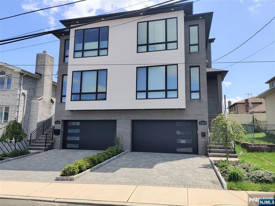 Built in 2020. Spacious contemporary 3 bedroom duplex located in Fort Lee. Open living concept on the main level with 9 ft. ceilings. Living room with custom built-ins, sleek fireplace and detailed ceiling molding work. Kitchen with large center island, stainless steel appliances, plenty of cabinetry, custom built-in with entertainment center and access to deck. Ground floor with entry mudroom leading to large rec room & half bath. Convenient to schools, NYC transportation, shops, restaurants and all major roads. No pets.