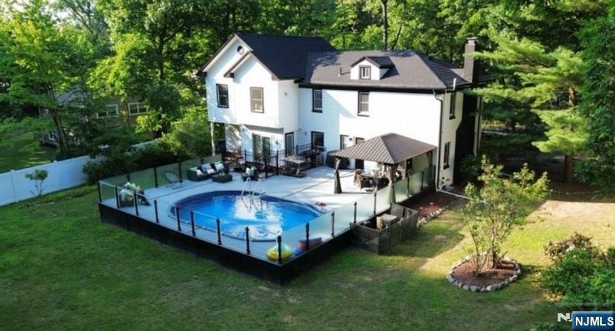 Welcome to this beautifully updated colonial with a custom addition, set on nearly half an acre in the sought-after Upper Fairmount neighborhood. Ideally located across from Staib Park and tucked away on a quiet dead-end street, this home offers space, privacy, and convenience. The 4-bedroom, 3.5-bath layout features an open and inviting design with hardwood floors throughout the main living areas. The modern kitchen is equipped with granite countertops, stainless steel appliances, and stylish lighting. The primary suite offers a spa-like bath with a rainfall shower and jetted soaking tub for ultimate relaxation. Outdoor living shines with a resort-style pool, sleek glass fencing, and an expansive deck perfect for entertaining. Additional highlights include a circular driveway with ample parking, updated HVAC and water heater, smart irrigation, exterior lighting, and elegant Starphire glass details.