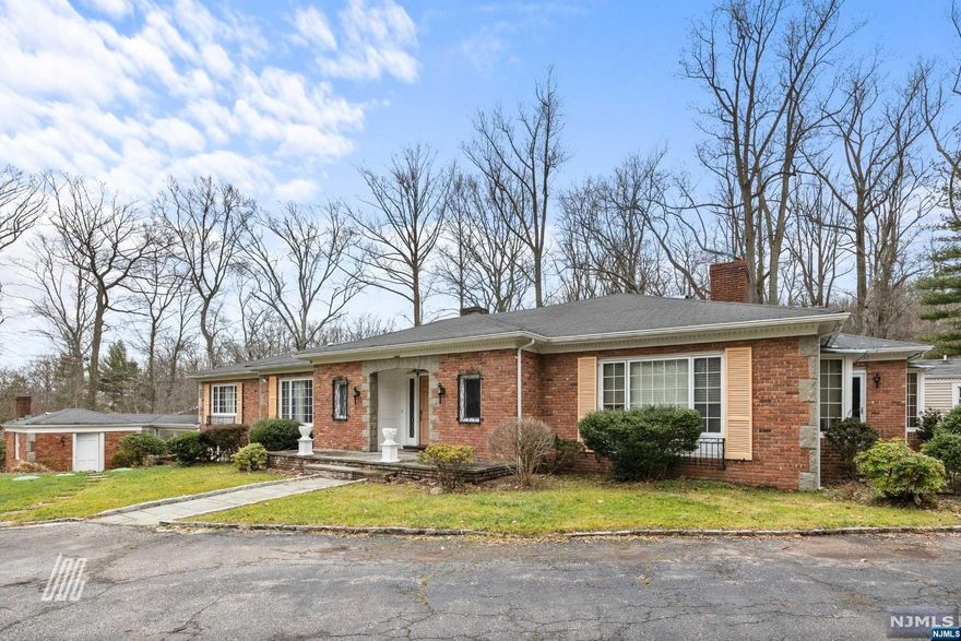 Nestled on 1.8 acres of serene property with a babbling brook, this sprawling brick ranch welcomes you with its circular driveway and picturesque bridge. The main house boasts 5 fireplaces as well as, 5 bedrooms and 5 bathrooms. Hardwood floors grace the interior, which features a modern eat-in kitchen and updated bathrooms. A separate building offers versatility with a wood-burning fireplace, ideal for an office or workshop. With tranquil surroundings, this 5-bedroom, 5-bathroom home epitomizes comfort. It's a nature lover's dream awaiting its next fortunate owner. Home is being sold 'As Is.'