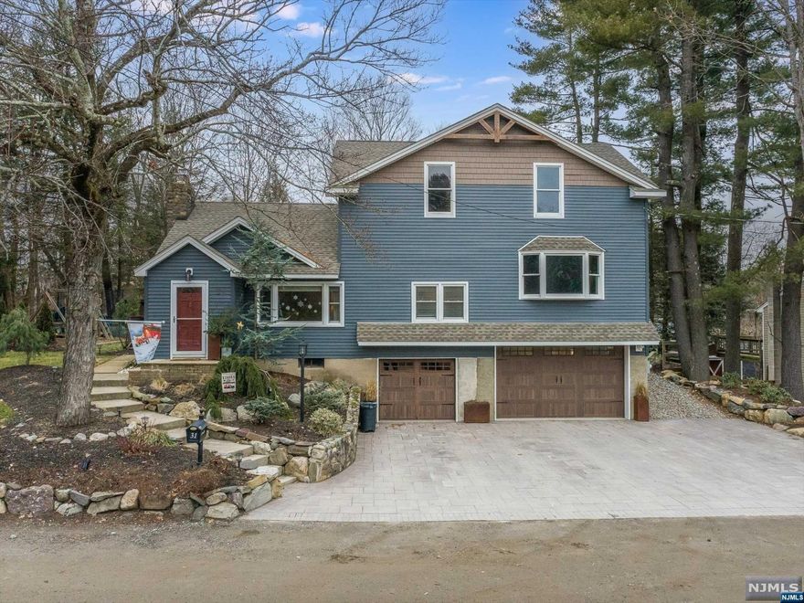 One of a kind custom home in Upper Greenwood Lake community that's been renovated in 2017. Step inside this gorgeous home to the main level which offers a living room with wood burning fireplace, formal dining room, eat in kitchen, full bathroom, large master suite with own full bathroom, and an office. Upstairs, the second level has a bonus foyer/ living space, along with 3 spacious bedrooms, a full bathroom, and a bonus room that can be used for extra living space. The finished basement features a nice space for a media room, laundry/ storage room, and 2 separate garages. One garage is currently being used as a gym, the other is an oversized garage/ workshop. Outside, the backyard with pristine deck and built in fire pit is perfect for entertaining or relaxation. This home also offers a custom paver patio driveway and extremely low taxes! Very close to Upper Greenwood Lake where they offer boating, swimming, and great hiking.