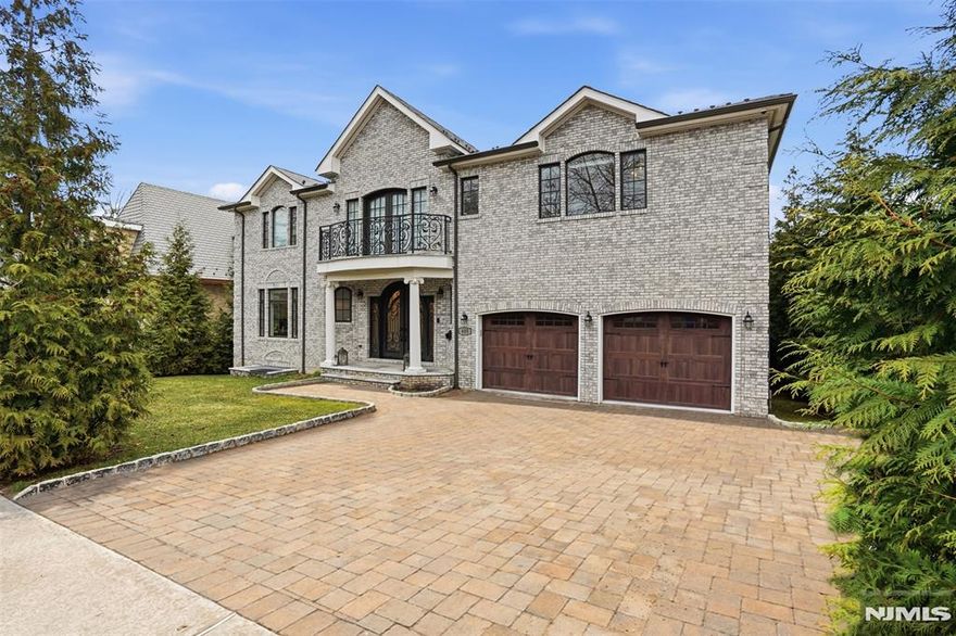 Experience a South-facing all-brick architectural masterpiece situated on a stunning property with waterfront views of Miller's Pond. This grand estate features a marble entry foyer that introduces a magnificent open floor plan where walls of glass frame the serene landscape. The great room, anchored by a classic wood-burning fireplace, is designed for gracious entertaining and seamless indoor-outdoor living. A magazine-worthy chef's kitchen boasts high-end appliances, granite counters, and a sun-drenched vaulted breakfast room with direct access to a stunning marble patio and full outdoor kitchen. Follow the marble walkway to your private oasis featuring a heated saltwater pool and custom waterfall. The expansive primary suite is a true sanctuary with a French balcony, steam shower,dual walk-in closets, and a spa-inspired luxury bath. All four additional bedrooms include en-suite baths, including a convenient first-floor suite perfect for guests or extended family. The home is further elevated by a full, finished walkout lower level designed for ultimate recreation, complete with a professional movie theater, private gym, wet bar, and a bedroom w/full bathroom. This tech-forward home features countless smart-home integrations, a whole-house water filtration system, surround sound, 3-zone high-efficiency heating and cooling, and a durable, composite roof. Located just minutes from NYC, this private retreat offers a rare blend of luxury, privacy, and modern convenience.