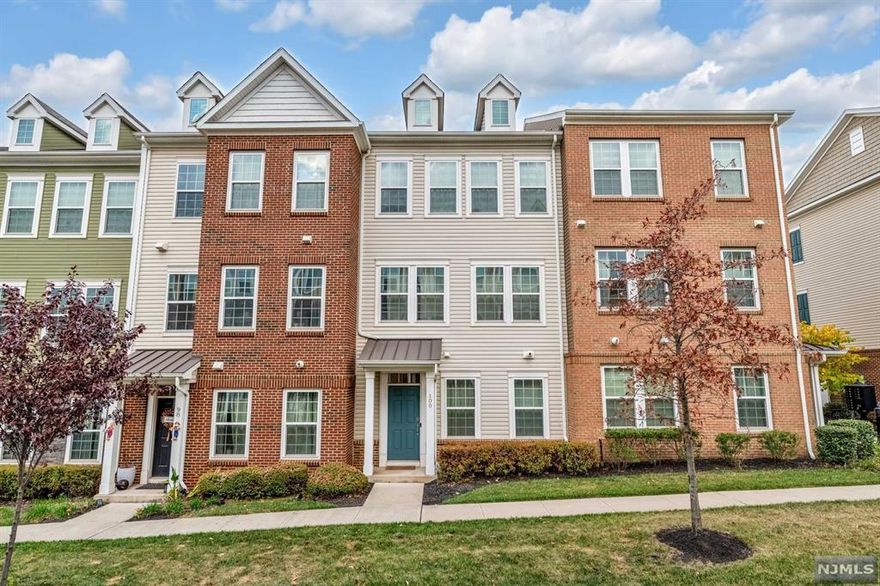 Welcome home to this stunning and well appointed 3 Bedroom / 3.5 Bathroom townhouse located in highly sought after Liberty Square at Wesmont Station. This ultra desirable model stretches across 1,935 SqFt throughout three floors and features only the finest finishes. Ground level features entry foyer, bedroom, full bathroom, two car garage, and utilities / storage. Travel to the second floor where you'll find a stunning, sun filled open concept including living room / dining room combo, Chef's kitchen, half bathroom, and trex deck, which is perfect for entertaining. Chef's kitchen includes SS appliances, large center island, custom cabinets, quartz countertops, and pantry. Completing this home on the third level is a spacious Master bedroom with ensuite bathroom and two walk-in closets, guest bedroom with ensuite bathroom, and laundry. Wesmont Station isn't just a community, it's a lifestyle featuring NJ Transit train station, Dunkin Donuts, and Wesmont Liquors. Don't miss out!