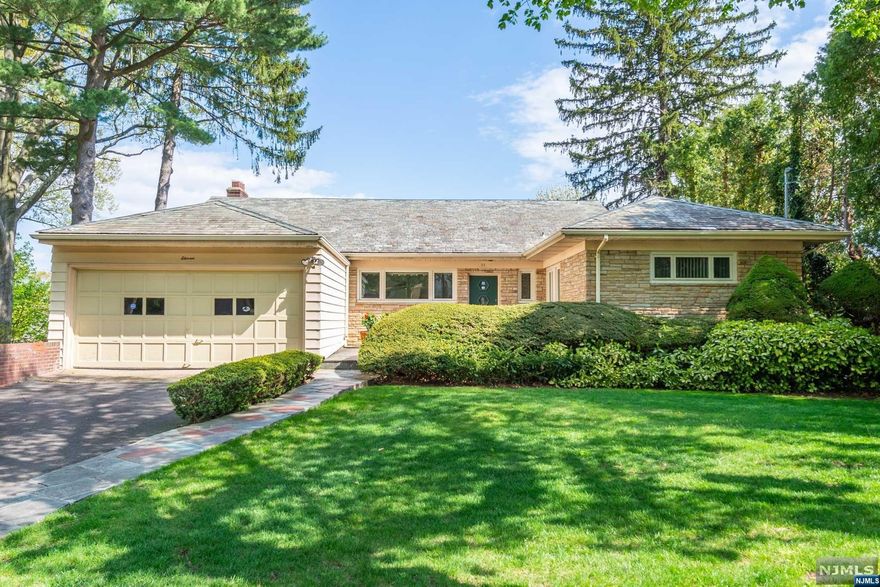 Stunning and inviting brick home with slate roof and gorgeous curb appeal featuring high ceilings, skylights, and a view of the New York City skyline. 4 bedrooms, 3 full and 2 half baths, herringbone hardwood floors, 2 fireplaces, sunroom, partially finished basement, attached 2 car garage, central A/C, oversized lot. Close to parks, schools, shops, transportation, and houses of worship.