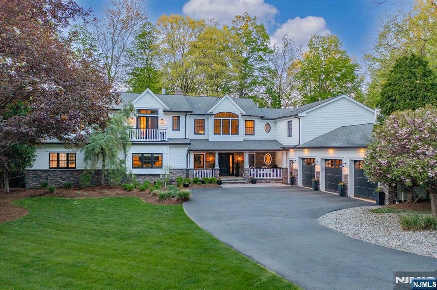 Breathtaking modern farmhouse with inviting front porch is tucked away on a serene private road offering 1.05 beautifully landscaped acres. This estate offers a stunning resort-like backyard, magazine-worthy kitchen, spa-inspired pool and hot tub, and seamless indoor-outdoor living. Light-filled open floor plan with high ceilings & luxury finishes throughout. Exquisitely designed layout features 5 spacious en-suite bedrooms including two primary suites. Designer kitchen with premium appliances, custom cabinetry, expansive seated island, and a walk-in butler pantry is the perfect extra prep space when hosting. Fabulous dining room with panoramic views of the rear oasis. Two-story great room with dual sided fireplace, family room with built-ins and fireplace, gorgeous powder room, and mud room with custom built-ins, laundry, and entry to custom 3-car garage complete the main level. Finished lower level with family room with fireplace, full bath, gym area, and bonus room. Designed for seamless indoor-outdoor living, this retreat opens effortlessly to a resort-style backyard. Lounge by the custom pool with sun shelf, water features, spa, fireplace, and a fully equipped outdoor kitchen! Access to top-ranked public and private schools nearby. Easy commute to NYC. Your private dream home in the perfect community.