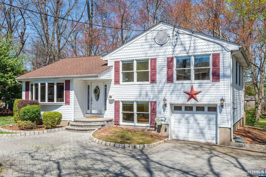 Amazing 4 BR,2 FB Split Level home in the wonderful town of Wyckoff. This home is perfect for everyday living and entertaining! The main floor offers a sun-filled Entry Foyer, Living Rm/Dining Rm, STUNNING kitchen W/huge seated island, granite counter tops, and ss appliances. This opens up to a spacious Great Rm W/FPL/vaulted ceiling and SGD to newer large deck that overlooks expansive, private back property. Upstairs you will find 3 large, airy bedrooms and a full bath. The lower level boasts another BR,FB and Laundry. The basement is ready to be finished and offers plenty of storage. Amenities include: gleaming hardwood floors,1 car attached garage, circular driveway,200 amp electric, newer deck 2020, newer CAC 2020....Low property taxes. Excellent Schools!
