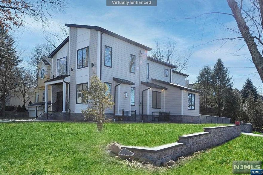 The best priced New Construction in Tenafly .ENCOMPASSING THE TRUE MEANING OF LUXUHRIOUS LIVING. INTRICATE DETAIL IN DESIGN AND ARCHITECTURAL BRILLIANCE FOSTERED THROUGHOUT. Located in Tenafly's exclusive and prestigious East Hill. This open concept custom built with top-of-the-line materials. The ground level/ basement area features a bedroom, a full bath, and a wet bar/wine cooler with an entertaining area. The first floor features a 2 story entry foyer, Living Room with a fireplace, Dinning Room, FASHIONED WITH a STATE-OF-THE-ART GOURMET CHEF'S DREAM KITCHEN with Viking appliances. This floor also includes a guest bedroom and a full bath. The second floor showcases a beautiful private master bedroom/master bath wing with a walk-in closet and a gas fireplace. 2nd-floor bathrooms have heated flooring. More highlights include hardwood floors throughout,2 car garages, 4 additional parking spaces, and a laundry room on the second floor. pre-wired for a generator & electric vehic