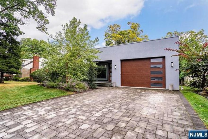 Just unpack! North Cliff Stunner, builders own, custom contemporary home. This magnificent, completely re-done 4-BR, 4.1-BTH home located in the sought after North Cliffs in one of Bergen County's top neighborhoods. Featuring a completely open floor plan w/hdwd floors throughout. Walk into the EF with vaulted ceilings and gorgeous exposed wood beams containing to the spacious LR with gas fireplace, dining room perfect for family gatherings and the modern kitchen with center island with waterfall countertops. The Primary bed with magnificent spa bath is conveniently located on the main floor as is the laundry and a cozy den fitted with ceiling projector connections plus a powder room. The deck leading off the back is surrounded by mature landscaping giving great privacy. Upstairs are 3 spacious bedrooms, one with an en-suite and two jack and jill style BRs, full bth. The basement living space has a family room, bedroom with full bath.