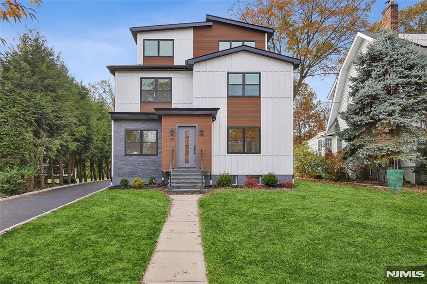 This stunning newly rebuilt luxury home offers over 3,000 sqft living space, plus a finished basement & 2-car garage, nestled in the desirable South Mountain neighborhood. With 6 spacious BRS and 4 full Bathrooms, this home blends modern elegance with comfort. The open-concept layout is perfect for everyday living & entertaining. The chef's gourmet kitchen features Thermador appliances, a waterfall quartz island & abundant natural light. It flows into the family room w/a cozy fireplace & doors leading to a large deck & private backyard. The main level includes a bright BR/office, full bath, formal dining rm, breakfast area, and living rm. Upstairs, the primary suite has a walk-in closet and a spa-like ensuite bath with a soaking tub, stall shower, double vanity. Three additional BRS and a full bath complete the second level. The sunny third floor offers a BR, full bath, and office space. Conveniently located near schools, parks, downtown Millburn, Midtown Direct train station.