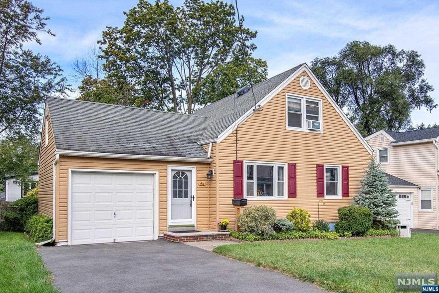 Move right in to this spacious 3 BR cape! Large entry breezeway, open living room / dining room. Modern eat in kitchen with quartz countertops, island with seating and storage, and stainless steel appliances. 1st floor bedroom and full bath. Upstairs two bedrooms. Newly painted and new carpeting. Basement has a separate outside entry leading to two semi-finished rooms plus storage and laundry. Newer furnace, hot water heater, and vinyl siding. One car attached garage with storage. Terrific location on quiet street close to Dumont's Memorial Park, Grant School, local shopping and NY transportation.