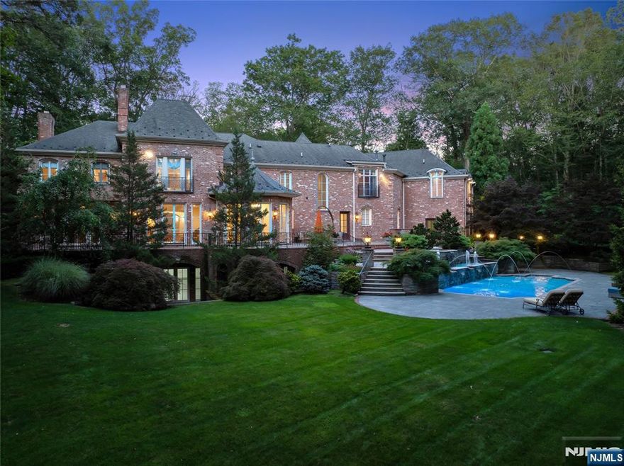 Set behind stately iron gates on one of Saddle Riverâ€™s most coveted streets, this French-inspired estate offers nearly 9,000sf of timeless architecture, privacy, & refined living. Perfectly situated on 2.15 landscaped acres, the home blends grand-scale entertaining with intimate everyday comfort, complete with resort-style amenities. A dramatic two-story foyer opens to sun-drenched formal living & dining rooms, anchored by fireplace & floor-to-ceiling arched windows. A fully appointed butlerâ€™s pantry complements the banquet-sized dining room. Chefâ€™s kitchen features top-tier appliances, oversized island & cathedral-ceiling breakfast area flowing seamlessly into the family room with coffered ceilings & custom built-ins. A rich wood-paneled library w/ fireplace & patio access create the ultimate home office. The 1st floor also offers mudroom, bonus/playroom, full cabana bath & 2 powder rooms. Upstairs, the mezzanine gallery leads to a private primary w/ sitting room, 2 fireplaces, 2 spa-like baths & expansive walk-in closets. The 4 additional bedrooms include 2 ensuites & 2 with Jack & Jill layout. The walk-out lower level features radiant heat, fifth fireplace & space for a theater, gym, wine cellar & guest suite. Outdoors, enjoy a heated saltwater pool w/ spa & fountain, outdoor kitchen & multiple terraces. A heated 4-car garage, radiant heat throughout, generator & advanced security complete this exceptional property with Saddle River taxes, top schools, & easy NYC com