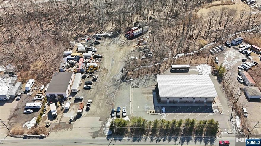 Heavy industrial commercial property in Netcong, Morris County. Exceptional opportunity to own a versatile income-producing heavy industrial property situated on approx 2.3 acres. This well equipped site is ideal for welders, contractors, fleet services, truck repair, inspections & operations or a business requiring a combination of indoor workspace & outdoor parking. The property features 2 buildings: Building 1 (constructed 2019) is 5000 sf, a newer high quality structure designed for heavy duty use. With 3 phase electric, efficient radiant heat & 5 oversized garage doors (4 in the rear and 1 on the side) allowing for a seamless access & workflow. Currently utilized for light bus/truck repair, this building is built to handle demanding industrial operations. Building 2 is 2400 sf perfectly suited for heavy repairs and secondary operations. This building features (2) 13 foot garage doors in the front and a 40x30 concrete pad in the back. The layout supports flexible mechanical work, storage & repairs. There is also a large trailer on site offering about 1000 sf of office space. The lot in between offers expansive yard area for parking, equip. vehicle & material storage. This is a rare combination of newer construction, functional layout & outdoor space in a strategic Morris County location w/easy access to major highways. Please note this listing consists of Block 8, Lots 28, 29, 30 sold as one unit.