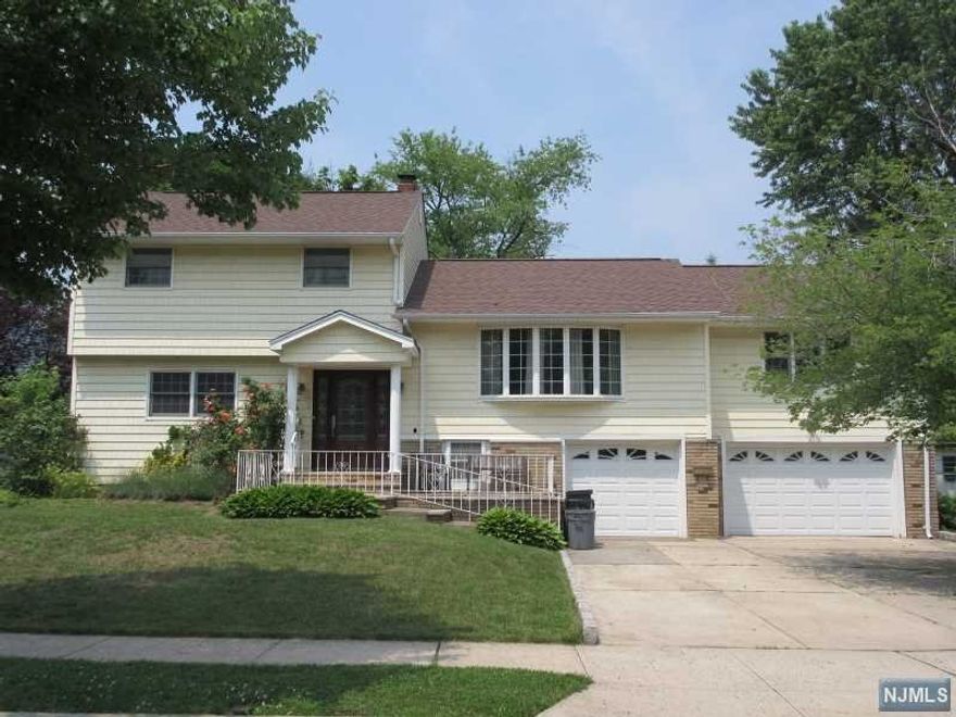 WOW! Custom home on CUL-DE-SAC is centrally located to shops, highways, schools, transp. Offers MANY improvements. Curb appeal invites you in. Main level has OPEN FLOOR plan. Stunning EIK w plenty of Wd Cabinets, Granite Ctrs/Breakfast Bar and SS Appls is opened to Dining Rm and Living Rm. MstrBdrm with 2 WIC and Private Full Bath has relaxing jetted Tub and Stall Shower. Ground level has 2 full size Bdrms and 2nd Renov Full Bath - Extended Family set up. Gorgeous Gleaming Hrdwd Flrs & Quality Anderson Windows. 2 Carwide Driveway leads to 2 Car Garg. Sizeable Yard w Paver Patio and Storage Shed. Cut through path in Cul-De-Sac provides path for short distance to Transp and shops on Broad St. A MUST SEE!