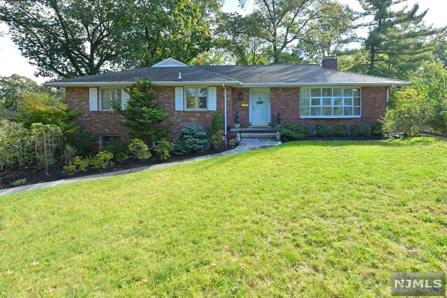 The potential is endless for this pristine brick ranch nestled on a deep 1/4-acre of beautifully landscaped property on a quiet tree-lined street. Main level has a welcoming entry foyer, large bright eat-in kitchen w/ timeless white cabinets, high-end appliances, skylight & oversize window to back greenery. The formal living room shares a cozy dual-side stone fireplace w/ a spacious formal dining room w/ classic built-ins. A light-filled sunroom w/ wood stove is surrounded by a charming private backyard patio. Also on main flr: master w/ ensuite FB & wall of closets; 2 more bedrooms, another full bath w/ relaxing whirlpool & separate steam shower. The lower level is ideal for extended family w a large bedroom & WI closet, a full bath, office/den, bonus room, laundry area w sink and fridge, & access to a 2 car tandem garage. New CA/C & furnace, basement Humidex, sprinklers, alarm. Convenient to houses of worship,transp/hiways, shopping.