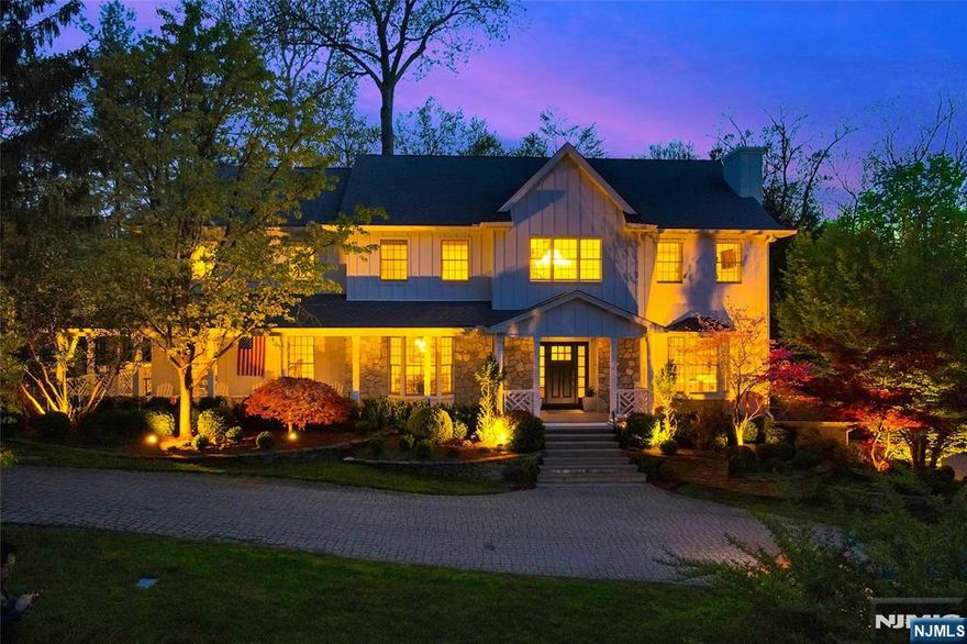 Perched atop Norwood's East Hill, this fully renovated modern farmhouse offers approx. 6,400 sq ft on over 1.5 private acres backing to 300 acres of preserved parkland with direct trail access and exceptional privacy. Soaring ceilings, expansive windows, and a sun-filled great room highlight the open layout. The chef's kitchen with Thermador appliances and custom Amish cabinetry anchors the main living areas, complemented by three fireplaces throughout the home. First floor features a guest bedroom and expansive home office, with sliding doors to a wraparound deck overlooking the pool. The finished lower level includes a home theater, gym, custom bar, and yard access. Upgrades include new flooring, designer baths with radiant heat, smart-home features, a 10-camera security system, and California Closets throughout. Exterior updates feature Hardie siding, a rebuilt porch, Trex decking, and landscaped grounds with a 65-light LED outdoor lighting system, a black lagoon-style pool/spa, waterfall, outdoor kitchen, and gas fire pit. 3-car garage. Cul-de-sac location near top schools and NYC access.