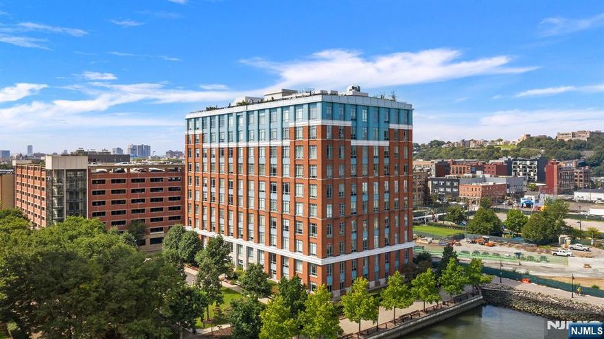 Exceptional northeast corner residence at Harborside Lofts. Residence 9F offers 1,842 sqft. with breathtaking Hudson River and NYC skyline views. This 2-bed, 2.5-bath home includes a versatile den, ideal as a home office, playroom, or guest space, and a gourmet kitchen with Miele appliances, a large island, and Snaidero cabinetry. Exclusive highlights include a private deeded rooftop terrace and a deeded parking spot in a covered garage. The primary suite features a marble bath, double vanity, and oversized shower, while high ceilings, oversized 13ft windows, and hardwood floors complete the elegant design. The building offers a 24-hour concierge, a private shuttle to the PATH, and access to 5-star amenities shared with 1450 Washington and 1400 Hudson St., including three gyms, childrenâ€™s playrooms, resident lounges, a rooftop pool, and billiards/game room. Conveniently located near the NYC ferry, parks, and vibrant dining and shopping, this home offers luxury, privacy, and convenience.