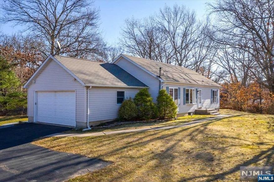 Welcome to this charming 3BR, 2BATH home, radiating both pride of ownership & move-in ready appeal! Elevated from the street, this property is located on top of its own hill in a private treelined setting. You'll be greeted by warm sunlight coming through the beautiful bay window overlooking the heart of the home. The LR boasts a built-in entertainment unit & trendy electric fireplace. The LR then seamlessly flows into an open concept kitchen w/SS appliance, large island w/built in microwave drawer and elegant quartz countertops throughout. Down the hall you'll find the 2 bedrooms, full bathroom & sophisticated primary suite nestled at the end of the hall. The fully finished basement adds valuable living space, featuring a bonus room perfect for a home office or gaming area. The long, private driveway that leads to the attached garage ensures ample parking with direct access to the kitchen. This outdoor space creates an ideal setting for entertaining or enjoying peaceful evenings