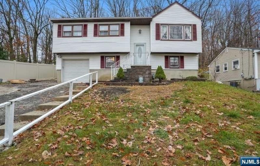 Situated on 1/3 of an acre in the White Meadow Lake community, this well-maintained bi-level home with 4 Bedrooms & 3 full baths with a built-in garage and driveway awaits you! Open floor concept, the main level has hardwood floors, features a living room, dining room, updated kitchen w/ granite countertop and stainless steel appliances with sliding doors to the rear to a new deck, 3 bedrooms, and 2 full updated tiled bathrooms. Master bedroom has its own private bathroom. Finished ground level with recreation room, 4th bedroom, full bath, and ceramic tile floors. Gas hot water baseboard heating system, Parking space for up to 6 cars in driveway. Situated in the White Meadow Lakes Association; dues are $840 per year and include the use of the Lake, beach, clubhouse, and park. Public sewer & water, water softener, natural gas.