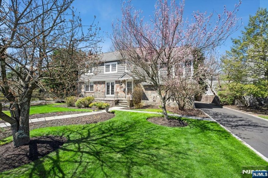 Timeless elegance meets everyday comfort in this beautifully crafted Colonial, nestled in one of Summitâ€™s most cherished neighborhoods. Lush, manicured gardens set a peaceful tone, while sunlight fills interiors with warmth. Rich hardwood floors, classic millwork, and a striking stone fireplace enhance the inviting flow. The chefâ€™s kitchen features custom cabinetry, quartz countertops, high-end appliances, and a decorative tin ceiling. French doors open to a charming porch, and an office with built-ins connects to the deck. A formal dining room, mudroom/laundry area, and powder room complete the main level. A cozy family room sits just off the main floor. Upstairs offers a tranquil primary suite with spa-like bath, a second ensuite, and two more bedrooms with a Jack-and-Jill bath. The finished lower level has a large rec room. Outside, enjoy a fenced yard with deck, patio, and soothing creek. Minutes to downtown Summit, top schools, and Midtown Direct trains to NYC.