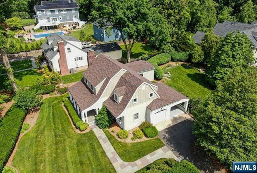 Majestic Dutch Colonial situated within an Oasis Setting and nestled in Ridgewood's Premier West Side Location. The lush plantings & bluestone walkways introduce a tranquil covered front porch perfect for enjoying views of the professionally landscaped grounds. Generous Living Room with wood burning fireplace leads into an oversized Formal Dining Room. The custom Kitchen offers expansive cabinetry and views of a stunning and secluded woodland backdrop. With its own connection to the lush rear landscape, the first floor Master Bedroom features a Porcelanosa Master Bath. A corner office and powder room complete the main level. The second level features a large secondary master and two sun-filled and oversized bedrooms with exceptional views. The full bath offers stunning finishes and radiant floors. The Finished Low Level offers a Rec. Rm and Full Bath. Close Proximity to Downtown and the Train Station. Tenant is responsible for utilities. Available for lease beginning July 15, 2025.