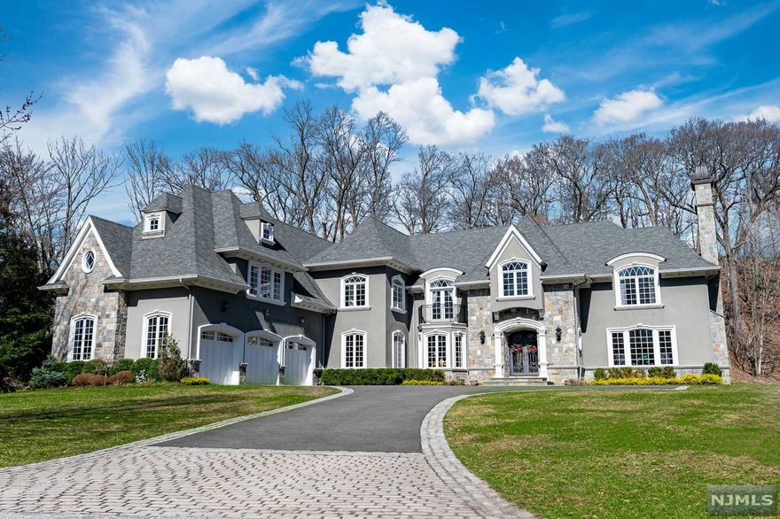 Renowned Builder's Own Private Residence which was completely custom built only 6 years ago. A palatial French Manor with 7,400+ sq ft of living space, sitting on nearly 1.5 acres. Enter into a dramatic entrance foyer with a grand staircase, continue along to perfectly appointed formal living and dining rooms. The kitchen is a chef's delight, featuring professional grade appliances, designer cabinetry, and a massive center island. The kitchen is open-concept and sits beside a two-story family room with soaring windows and a full wet-bar. Upstairs you with find 4 generously sized bedrooms, 3 more full bathrooms, and master wing fully equipped with dual closets and a spa-like master bathroom. Upgrades galore, including 6zone central air, home security, a home library, 4 machine laundry, and so much more.. The grounds are lush and green, with plenty of room for a pool. Sitting at the end of a quiet cul-de-sac with lake views, you will never want to leave this luxurious oasis.