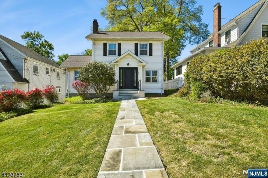 Quality and STYLE! Located in the prestigious Upper Gregory section of West Orange, this Colonial has been meticulously renovated inside and out. A new bluestone walkway welcomes you to an open Living/Dining area filled w/ natural sunlight beautifully anchored by an original gas fireplace. The stunning kitchen is a showstopper, featuring custom solid wood cabinetry, new appliances & quartz countertops. Sliding doors reveal a chic powder room &laundry area, complete w/ a custom quartz folding station & ample storage. A den/office space completes this floor. The original turn-of-the-century staircase, carefully restored, leads to the second floor with two large bedrooms (one offering NYC views), an office, & a designer bathroom with drop-in tub and double sinks. One level up, the impressive primary offers NYC views and a sitting area. New wide-plank oak hardwood floors run through all three levels. The backyard is large & flat, perfect for entertaining or relaxing. A detached two-car garage & ample additional parking add convenience. The basement is unfinished and ready for your personal touch. Additional highlights include a new roof, new HVAC, new solid wood doors, all new electrical including new panel, recessed LED lighting throughout, & new water heater. Ideally located 0.3 miles from Gregory Elementary School on the border of South Orange and just minutes from NYC trains, bus, and jitney, this home is picture-perfect and truly move-in ready.
