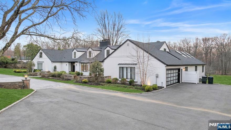 Welcome to 16 E Greenbrook Road situated on a pristine 2.44-acre parcel in the sought-after enclave of North Caldwell, This home presents a rare opportunity to own a fully renovated estate offering modern luxury. Set on an impressive 255 x 470 lot that backs to preserved woodlands, this residence delivers a tranquil, park-like setting while remaining just 19 miles from New York City. This unique modern ranch is over 5000 sq ft. Fully renovated in 2021 offering an ideal layout for everyday living and entertaining with 5 bedrooms and 5.5 bathrooms in the main house. This property has distinctive features such as an indoor pool . Enclosed within a dramatic space of sliding glass doors and 20+ foot vaulted ceilings. This area offers remarkable versatility and can be reimagined as a private indoor sports court, or bespoke venue tailored to your vision. Beyond the main residence, a fully renovated barn enhances the homes functionality. Thoughtfully updated, this space includes a full bathroom, garage door to open up the space and lofted bedroom. The barn offers endless possibilities to suit a modern lifestyle. The expansive grounds further distinguish this property, providing both usable open space andthe natural beauty of wooded surroundings. The depth and privacy of the lot create an exceptional outdoor environment with ample room for recreation, entertaining, future enhancements, or simply enjoying the peaceful setting Welcome Home!