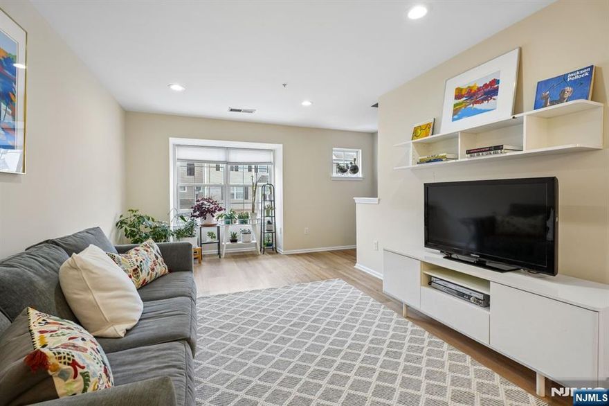 Contemporary, pristinely-maintained 2 bedroom, 2.5 bath condo in desirable Lion Gate community. On the Glen Ridge border, across from Glen Ridge Country Club, and Ideally located next to Lion Gate Park with walking paths, a Tot Lot, soccer fields and a 4-acre fresh water wetland. Open concept, two-floor unit with living room flowing to dining room and new floors throughout. Muted color palette is relaxing and blends with any decor. The sparkling white updated kitchen has an extended countertop that serves as a breakfast bar. All stainless steel appliances, pale wooden floor and so much cabinet/storage space. Eat-in kitchen opens to a cozy den with a gas fireplace and sliders to a private balcony. Ensuite Primary Bedroom on 2nd floor is spacious and sun-filled with walk-in closet. Bath includes a marble-topped double sink and separate tub and shower. Laundry also found on 2nd level. Second bedroom also on 2nd floor, with full bath in hall. Attached, ground-level garage means always easy parking, plus plenty of guest parking in the community. Unit also includes a powder room on main floor, and large storage space next to garage. Pets allowed.