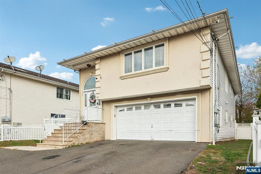 Welcome home to this well-maintained 5 bedroom 3.5 bathroom Multifamily residence situated in the heart of Garfield. Step into the welcoming entry foyer, which provides access to both apartments. Upstairs, you'll find a bright and inviting unit featuring a large living room with large windows that create a warm, comfortable atmosphere for relaxing or gathering. The living room flows seamlessly into the dining room, an ideal space for casual meals to lively celebrations. The dining room opens to the eat-in kitchen, highlighted by custom cabinetry, marble countertops, stainless steel appliances and cozy dining area. Down the hall, the generous primary bedroom includes large closet and private en suite. Two additional bedrooms, a full bathroom and in-unit laundry complete this level. The ground-floor unit offers an open-concept layout with a cozy living room perfect for unwinding at the end of the day. The adjoining eat-in kitchen features custom cabinetry, marble countertops and a comfortable dining space. Two bedrooms, a full bathroom powder room and laundry add convenience. From the first floor, find the rear deck an excellent setting for outdoor dining or lounging. The deck overlooks the backyard, complete with patio and fenced-in yard ideal for enjoying your favorite outdoor activities. A 2-car attached garage and ample driveway parking enhance everyday ease. All this, conveniently located near NYC transportation, shopping and dining. All separate utilities.