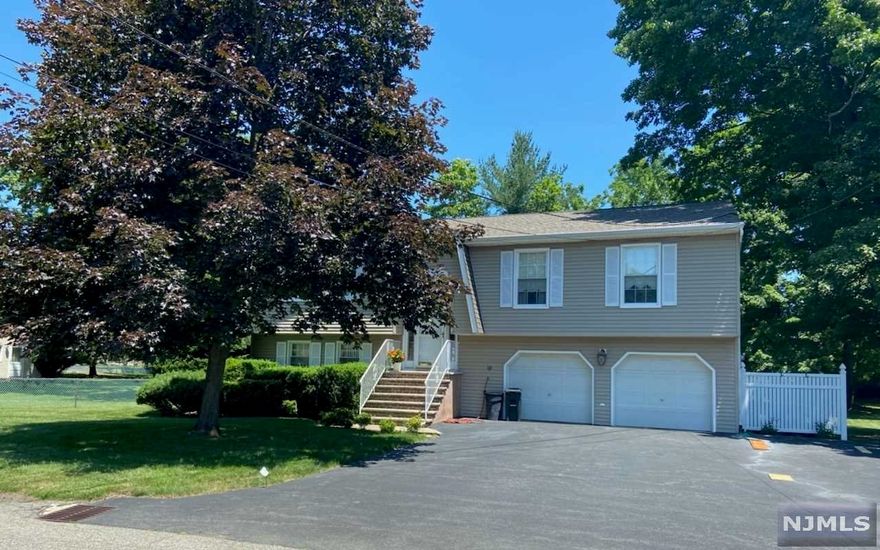 Wonderful home set on 1/2 acre lot. Convenient location. Located minutes to shopping, restaurants, town center, major highways and NJ transit. Updated windows and roof. Wood floors, granite. First level has living room, dining room, eat-in kitchen, 3 bedrooms and main bath. Lower level has large family room, laundry/utility room and powder room. Two car garage. Multi-zone heating. Central air - "as is".