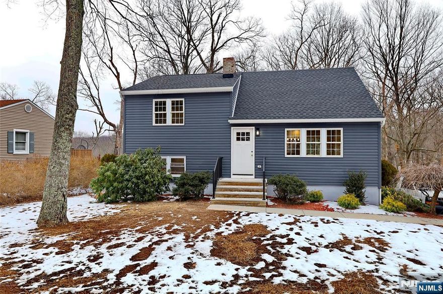 Modern fully renovated inside and out split level on an acre of the lot. Offers brand new septic system. Living room with electric fireplace, eat-in kitchen with ss appliances and island, slider door to the deck, 3 bedrooms and 2 full bathrooms, rec room, laundry and direct access to the yard. Central a/c, brand new windows, roof, hardwood floors, recessed lighting, 2 car garage. Enjoy open backyard with a entertaining deck! Great location, stylish finishes this home is a must-see!