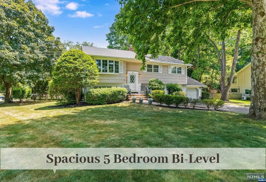 Sunlit Travell District Bi-Level set on inviting Cul de Sac with generous spaces is just moments to Schools and NYC Transport. Living Room with Bay Window seamlessly transitions to Formal Dining Room. Eat-In Kitchen has Sliding Doors to a lovely Deck convenient for Hosting, BBQing and enjoying Nature Views. Down the hall is a spacious Primary Bedroom w WIC, 2 more Bedrooms and Full Hall Bath with Double Sinks. The Lower Level offers inviting walkout Family Rm w Sliders to Paver Patio and 2 additional Bedrooms. Nearby is Laundry, Powder Rm, Utilities and access to Attached 2 Car Oversized Garage. Lovely Established Plantings set on Flat Property. Inquire about the Walking Path to Coach Park & Ride just blocks away. 42 Minutes to Port Authority. Wonderful opportunity to make Ridgewood Your New Home Town just in time for Summer Fun and Sept School Start.