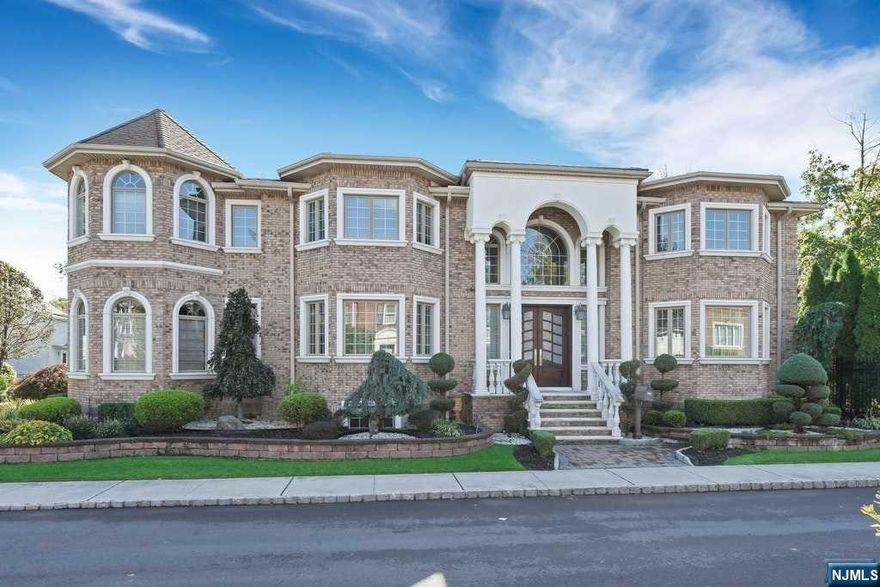 Majestic custom-built, 7 bdrm, 5 1/2 bath w/ all stately architectural details throughout. Fantastic 2-story entrance foyer with sweeping staircase. Formal living room, formal dining room, library w/ mahogany panel walls, great room with fireplace, large modern kitchen with center island, custom cabinets, high end appliances and French doors leading to private rear yard. Finishing 1st floor is half bath & laundry room. 2nd floor w/ primary bedroom suite, walk in closet, enormous primary bath with gas fireplace, circular whirlpool tub, two bedrooms with full baths & two bedrooms with Jack and Jill bath. Basement level has wine cellar, spa w/ sauna and shower, media room with Fireplace, one bedroom and fireplace, rec room, gym, 1 bedroom w/ bath. Features include 4 Zone C/AC, 3 gas fireplaces, 8 zone heat, neutral gas generator, security system and more. Move right into to this majestic home located in prime Fort Lee area minutes from NYC.