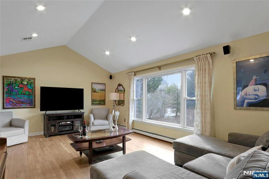 This exceptional 4 Bedroom 3 Bath Renovated South facing light & bright BiLevel offers an incredible lifestyle & it's just a stroll from the picturesque town center, w/excellent schools, fine restaurants, & NYC bus & rail. A stunning Cathedral Ceiling Living Rm & Dining Rm/gleaming hardwood floors sets the tone. A Kitchen w/updated cabinetry & stainless appliances opens to the 2Tier Trex deck & fenced in spacious rear yard, paver patio & pool, your sanctuary from the outside world. The Main Level has three bedrooms/hardwd floors (incl Primary) & two beautiful Baths. The Cathedral Primary Suite w/Primary Bath is your hideaway. The Ground Level, another full level of living, has access to the private rear yard & 2 Car Garage, PLUS a Family Rm for your Wide Screen TV. The spacious 4th Bedroom & Bath/SS, is a perfect Extended Family opportunity, PLUS laundry Room. BBHW Heat & CAC. Stroll to Seasonal Outdoor Concerts, restaurants, & Town Library. It's suburban living at its finest!