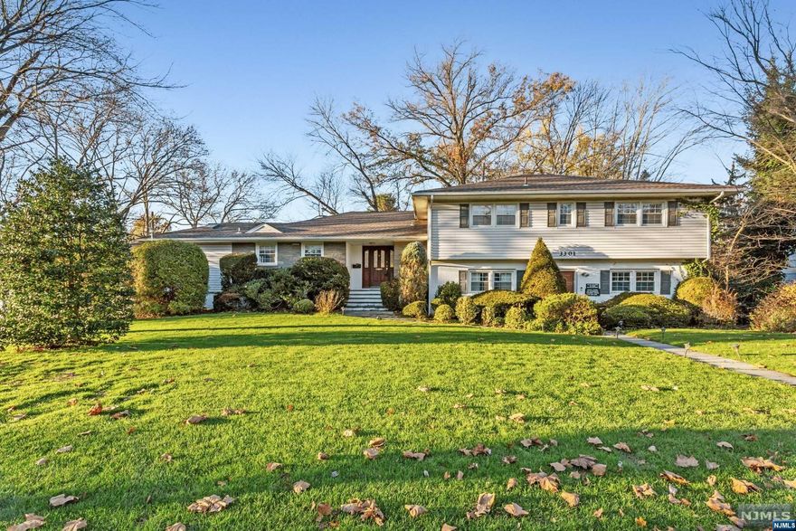 Welcome to this gorgeous split level home in the heart of one of most desired towns of Bergen County! Walk into the entry way flooding with natural light & find your fully updated kitchen, oversized formal living room & dining room w/ fire place & hardwood floors throughout, family room (w/ addtl fireplace), powder room & sliding glass doors off kitchen & family room leading to your oversized deck/expansive backyard! The Second Floor features 4 large bedrooms including Master Bdrm w/ walk in closet & master bath, plus Jr. Master Suite w/ full bath! Extended family set up provides home office w/ 6 offices spaces (could be converted into bedrooms), previously used as doctor's practice, plus laundry room. Walk downstairs to finished, spotless basement w/ updated floors, plenty of storage, & your very own home steam room/sauna! 2 car garage, walking distance to shops/restaurants/schools/parks, house of worship. Incredible Radburn location, waiting for it's next owner to call it home!