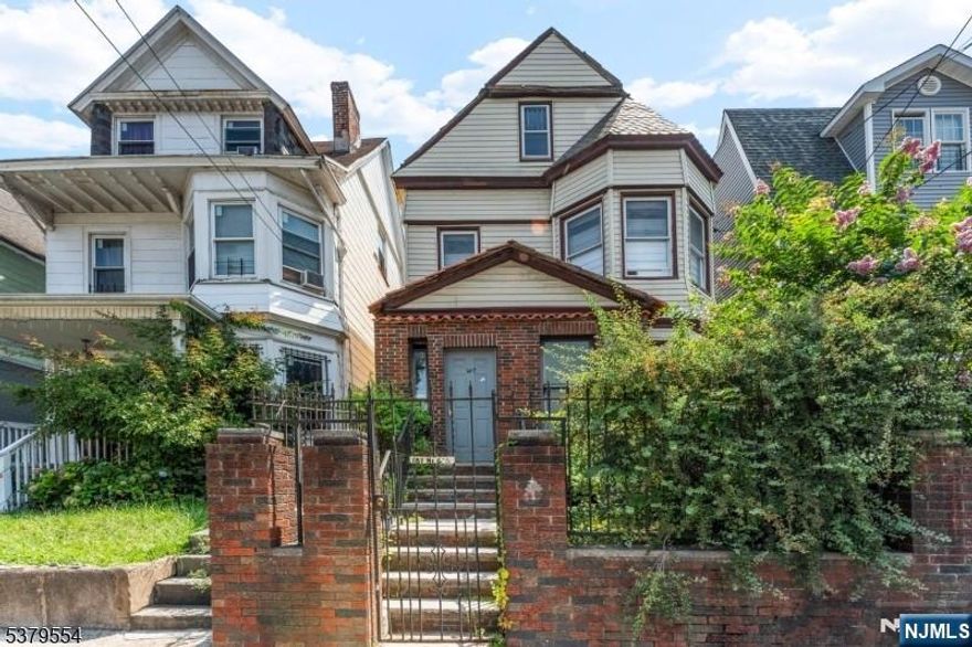 Welcome to this charming 3-story Newark home! Bursting with character, it features soaring ceilings, abundant natural light, and a seamless blend of timeless details with modern upgrades.The main level boasts an updated kitchen with granite countertops, tall cherry wood cabinetry, stainless steel appliances, and ample counter space.Multiple living areas offer flexibility for entertaining or everyday comfort.Upstairs you'll find 3 generously sized bedrooms with beautiful hardwood plank floors. The third floor adds 2 more bedrooms, perfect for guests or office space.Original hardwood plank flooring and preserved architectural touches are complemented by tasteful updates throughout.Enjoy additional space and versatility with a large basement and a private yard, perfect for recreation, storage, or outdoor gatherings. Conveniently located near schools, parks, shopping, dining, and transportation this home has it all!