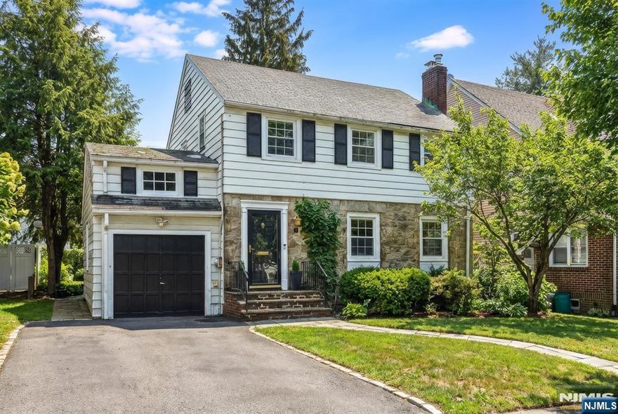 This beautifully scaled and well-appointed side-hall colonial set in Bloomfield's coveted Oak View neighborhood will steal your heart. Inside, a stylish interior showcases charming architectural character, refined finishes, beautiful wood floors throughout, and a spacious layout that flows effortlessly. The main living area, anchored by a classic wood-burning fireplace, transitions gracefully from room to room and unfolds into the spectacular expansive media room with built ins, floor-to-ceiling windows and skylights bathe the space in natural light. The sweeping views overlook a wide, fully fenced, backyard that is private & perfect for both everyday living and entertaining. The chic kitchen offers ample storage & marble countertops, move-in ready today with the opportunity to personalize over time. Upstairs, 3 bright good-sized bedrooms and a spacious main bath provide sanctuary and versatility. The large primary BR features Jack-and-Jill custom closets create a functional and serene retreat. The full attic provides excellent storage, while the high-ceilinged basement offers abundant space and excellent potential for future finished living areas. The convenience of the attached garage guarantees that you will always stay dry. Underground sprinklers, French Drains and a new sump pump. Set on a quiet residential street just two blocks from Bloomfield's sought-after Oak View School, NYC bus 2 blocks away, this is the home that buyers wait for. 5 Collins is the tax address.