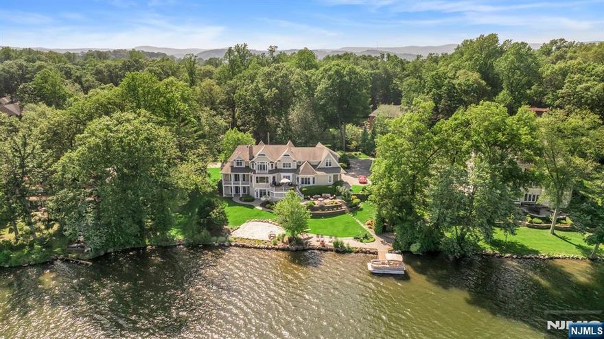 Welcome to this exceptional lakefront home in the highly desirable Pines Lake community. Situated on a beautifully landscaped 0.7-acre lot, this residence offers breathtaking water views, refined interior spaces, and resort-style outdoor living. Elegant two-story foyer with formal living and dining rooms. Stunning gourmet kitchen with center island, high-end appliances, breakfast area, and butler pantry. Expansive family room with fireplace and walls of windows overlooking the lake. Office/den with a full bath perfect as a guest room or first-floor bedroom option.10-foot ceilings and seamless flow to a large entertaining deck. Grand primary suite featuring two spacious walk-in closets, a Spa-like bathroom with radiant heated floors. Four additional Bedrooms, en-suite baths, bonus room/playroom for flexible use. Finished Walk-Out Lower Level: Home theater/media room. Game room/recreation area. Full gym room. Guest bedroom with full bath. Direct access to the patio and private lakefront yard.Outdoor Oasis: Private dock, patio by the water, and multiple balconies and decks. Lush professional landscaping and a tranquil setting. Radiant heat in both the primary bathroom and the lower level for added comfort. Pines Lake Community Lifestyle: Enjoy Lake Life with/ vacation every day. Enjoy year-round access to boating, swimming, kayaking, paddleboarding, fishing, sailing, and vibrant community events like movie nights and summer programs.