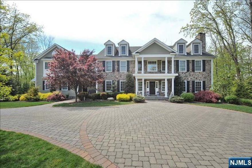 Situated on over 2.5 picturesque acres, this center hall colonial is move in ready and pristine both inside and out. The home offers approx. 6300 sf on the 1st and 2nd floor, plus a large finished walk out lower level comprised of a theater area, recreation area, gym & office/craft room, storage & utilities. 2 story foyer, living room w/fpl, large family room w/fpl & built-ins, formal dining room, spacious eat-in kitchen w/state of the art appliances, office/library & 2 powder rooms. The 2nd floor offers a large primary bedroom/sitting room/luxury bath & fitted walk-in closets. 4 additional bedrooms, 3 baths(2 ensuite) & laundry room. The lushly, professionally landscaped rear yard offers complete privacy, an Anthony/Sylvan lagoon pool w/extensive stone waterfalls, huge paver patio, large deck & walkways making this a very Special Property. 3 car garage, circular paver driveway.