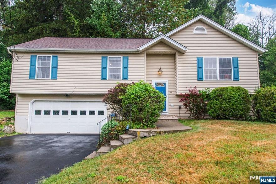 Bi Level home boasts New Kitchen w/ State of the Art Stainless Appliances ,Access this Private backyard thru the Dining Room sliders to the Deck situated on Beautiful Wooded Backyard,Hardwood floors thru-out,Vaulted Living Room ceiling,3 Nice sized Bedrooms,Primary has Walk in Closet and Full Bath,Lower Level has Built in Large Family Room,Desk Area,1/2 bath,Laundry room and Two car Garage,New Roof,windows,Driveway,Freshly Painted Deck, Door & Shutters!! This home shows true Pride of Ownership and is sure to please All.