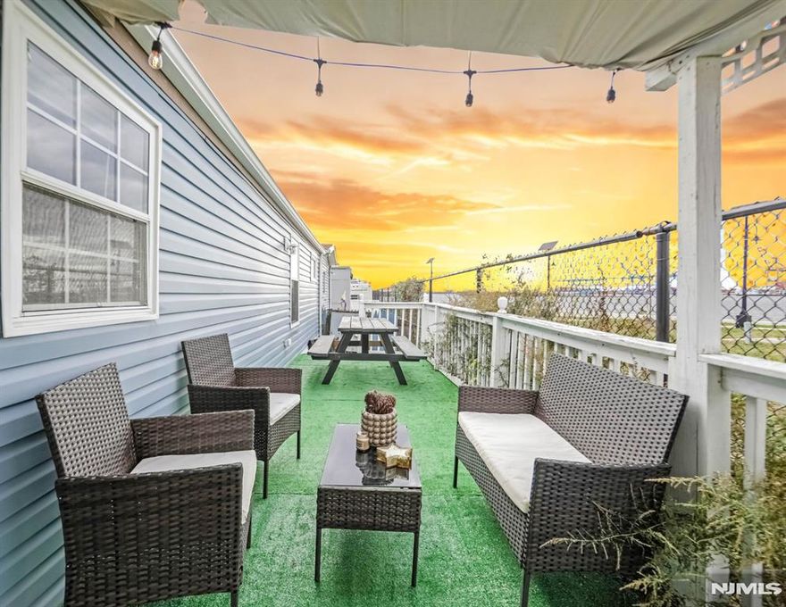 Welcome to UNIT B22, A waterfront 2-Bed, 1-Bath Manufactured Home in Bayonne Only 20 Minutes from NYC! Wake up to ocean views, evening sunsets and serene waterfront living. Fully and beautifully renovated, HOA of only $960 which includes one parking space. This home is uniquely positioned directly on the water with no front-facing neighbors, just open skies and the tranquil bay right outside. You'll find: A spacious owner's suite, a secret second bedroom tucked behind a beautifully crafted bookshelf door a one-of-a-kind feature! Modern flooring, Open-concept layout, In-unit laundry, and skylights throughout. Step onto the inviting waterfront porch, with the perfect setting for relaxation, al fresco dining or sunset watching. Additionally the home includes a compact side yard, perfect for a herb garden, play, or additional outdoor seating. Whether you're sipping your morning coffee or entertaining guests, the porch and side yard seamlessly blends indoor comfort with the natural beauty of the shoreline. A peaceful community, gazebos, and playgrounds, perfect for morning strolls or sunset views. With a designated parking, this home blends comfort, style and convenience in one of Bayonne's best-kept secrets. Just minutes from local shops, restaurants, and easy access to NYC transit. Unbeatable combination of location, lifestyle, and value. Whether you're downsizing, investing, or looking for a peaceful retreat near the City. Schedule your private showing!