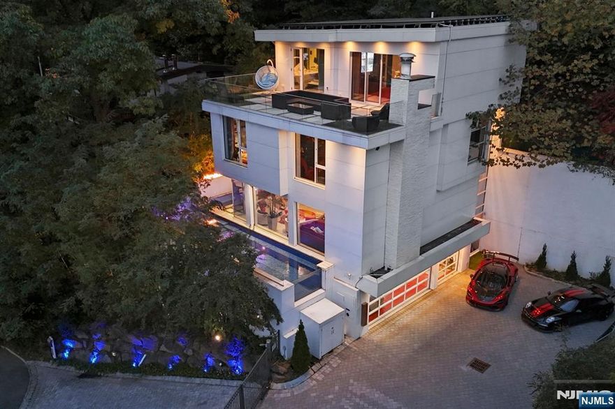 Where Modern West Coast Living Meets the Gold Coast â€“ Discover contemporary luxury in this custom-built masterpiece, privately situated at the end of a gated cul-de-sac in Edgewaterâ€™s most coveted enclave. Inspired by West Coast modernism, the home embodies light, openness, and effortless sophisticationâ€”framed by sweeping panoramic views of the Manhattan skyline from every level. The sun-drenched open floor plan showcases clean architectural lines, soaring ceilings, and designer finishes throughout. At its heart, a gourmet chefâ€™s kitchen flows seamlessly into the living and dining areas, extending to an outdoor oasis with a custom showcase poolâ€”perfect for entertaining or quiet reflection. The top-floor primary suite serves as a tranquil retreat, featuring floor-to-ceiling glass, a spa-like bath, and a private terrace with unobstructed skyline vistas. Additional bedrooms and flexible spaces provide versatility for guests, work, or leisure. Designed for comfort and innovation, the home includes radiant heated floors, an in-home glass elevator, custom wine display, a custom aquarium, generator, and multiple terraces that blur indoor-outdoor boundaries. A rare six-car garage with hydraulic lifts completes this exceptional residenceâ€”an unmatched offering in Edgewaterâ€™s luxury market. Every element reflects refined taste and modern craftsmanship, creating a serene sanctuary just minutes from Manhattan. ALSO AVAILABLE MLS# 25040350