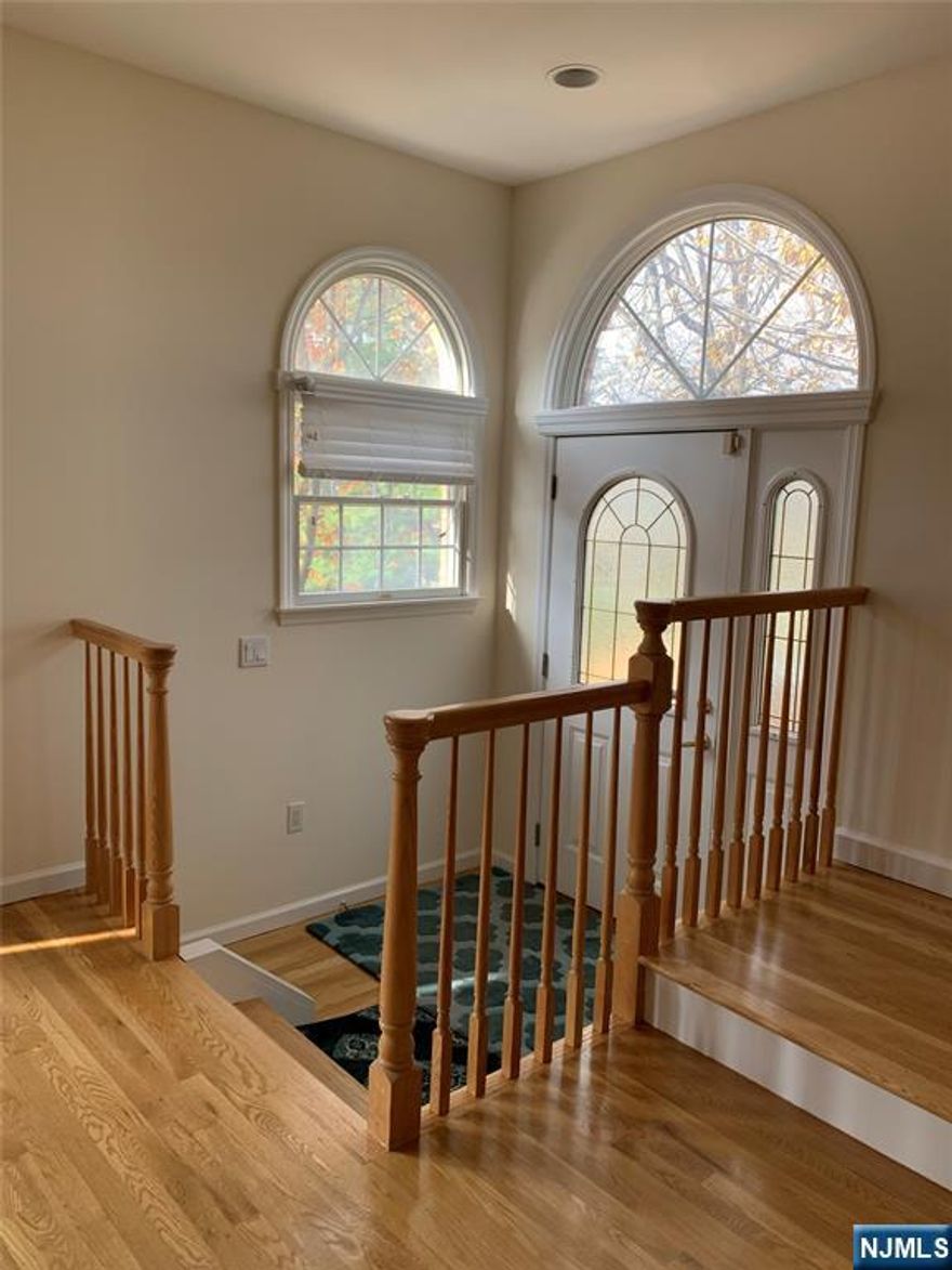 Bright and spacious 3-bedroom, 3.5-bath end-unit townhouse, privately located at the back of the complex. An open entry foyer opens to a generous living and dining area, ideal for both everyday living and entertaining. The kitchen features double wall ovens, granite countertops, stainless steel GE Profile appliances and a bright breakfast area. The inviting family room offers a gas fireplace and sliding glass doors to a private deck, complete with a gas line ready for BBQ. The primary suite includes a walk-in closet and a spa-like bathroom with double vanity, Jacuzzi tub, and a separate shower stall. A versatile ground-floor multi-purpose room with a full bathroom is perfect for guests, a home office, or recreation space. Additional highlights include hardwood floors on the first and second levels, two-zone heating and central air conditioning. Conveniently located with NYC bus service directly in front of the complex and access to a nationally top-ranked high school.