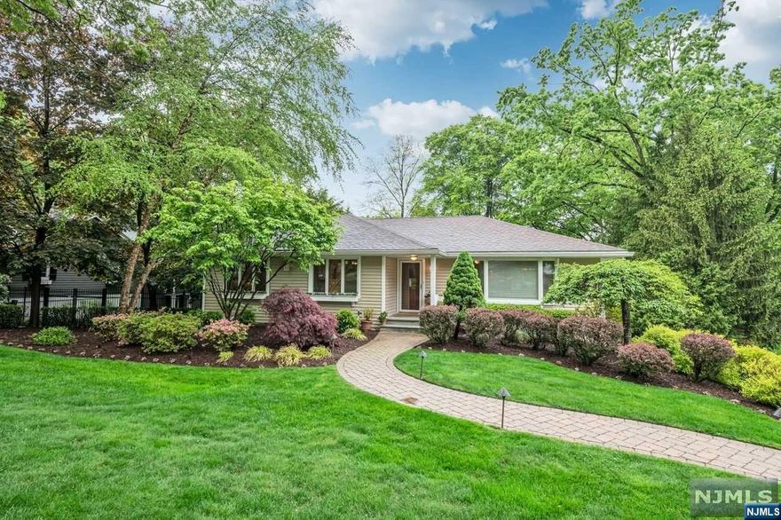 Come explore the tranquil setting and all that this amazing home has to offer. Abundant natural light glistens on the hardwood floors of the spacious Living RM with vaulted ceiling. The Dining Room and Kitchen are ready for both casual and formal entertaining. Oversized windows provide views of the STUNNING BACKYARD. Main level continues with Primary Ensuite, two bedrooms and full Bath. Lower level boasts a warm and inviting Family Room, with stone Fireplace and a bonus Office or Bedroom. French Doors and wall of windows offer easy access to the gorgeous property. You will love the COMPLETE SUITE with bedroom, full Bath, living/dining area and kitchen. Perfect for multi-generational living, this separate space provides 547 SF of privacy and comfortable living. Memories will be made when family and friends gather in the backyard OASIS. Parties are easy with built-in grill, al fresco dining, fountain, perennial gardens and firepit. This dream home MUST BE SEEN!