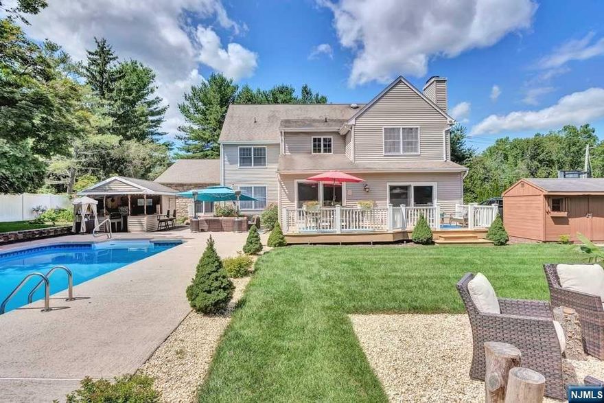 Stunning 5BR, 4.5bath, approx 4000sf of incredible living space with new 2022 addition. This beautiful home features 2 primary ensuite bedrooms (1st & 2nd flrs) both w/ spacious spa baths & WIC's, providing ultimate flexibility for extended living and comfort. The open-concept layout features a generous kitchen with ss appls/granite, island & peninsula, flowing into a bright living & dining area with gas fireplace, ideal for entertaining. Add'l 3brs are generously sized, each offering ample closet space. Step outside to your private oasis, where a meticulously landscaped garden & yard awaits with firepit & expansive play area.The centerpiece is a sparkling in-ground pool, complemented by a stylish cabana w/ a prof range, rotisserie, sink & 1/2 bath perfect for summer gatherings, outdoor dining, or simply relaxing in the shade. Finished basement, 2 laundry areas (on 1st & 2nd flrs), steps to town and close to transportation,this home blends luxury and comfort effortlessly.