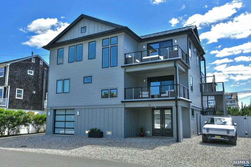 Get in now & enjoy Summer 2025! All new & turn key, this custom architectural gem boasts 4+ spacious bedrooms & 4 large baths. Breathtaking views of ocean & bay from main living space. Reverse living, open concept kitchen, high end appliances (Miele, Sub-Zero) flowing into living & dining areas, deck w/ocean views & motorized pergola on 3rd floor, elevator service, ADA accessible guest bedroom & bath w/zero threshold shower. Wi-Fi boosters, wired sound system & exterior cameras. 2 additional outdoor decks to enjoy bay views. Just 1 house from walking path to beach & bay. Low maintenance JamesHardie exterior, 2 outdoor showers plus yoga studio/recreation area on ground level. Convenient to both Manto & Bay Head Yacht Clubs & town. Leave your worries & come live the perfect beach lifestyle!