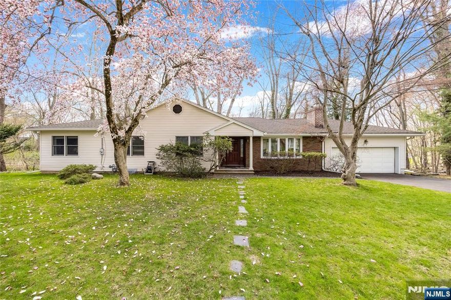 Charming, expanded Ranch style home affording all the conveniences of one floor living, primary bedroom and bath w/steam shower and jetted tub, large walk in closet, fully finished basement includes rec. room, office, laundry, storage and half bath. Living room w/wood burning fireplace, SGD from dining room to large/oversized deck overlooking private, heavily wooded section of Borough owned property. Other features include: central A/C, oversized (2) car garage, Anderson vinyl replacement windows where installed, gleaming hardwood floors, updated furnace (2019). Schools, houses of worship & downtown conveniently located nearby. Highly rated schools from ES through HS (Northern Valley Demarest HS). Easy access to GWB/NYC via 9W or the PIP. This special home with curb appeal galore is located in a quiet residential neighborhood and only awaits your finishing touches & personalization. Home is being sold in "as-is" condition (no known issues/concerns).