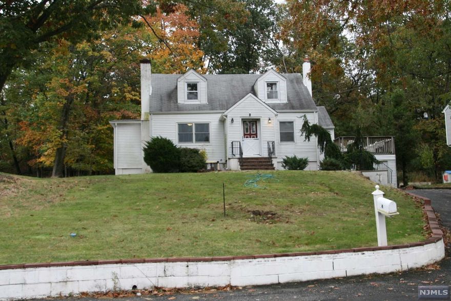 Quiet low traffic residential street location. Nestled on a knoll above the street, this home has an open and level back yard with woods at the rear of the property that afford great privacy. Recently Redone "open concept" kitchen has a breakfast room with door to rear yard and deck area. Four bedrooms, two full baths, recently redone floors, fireplace in the living room, a great property, a garage... This home offers expansion possibilities too. You won't want to miss this one!